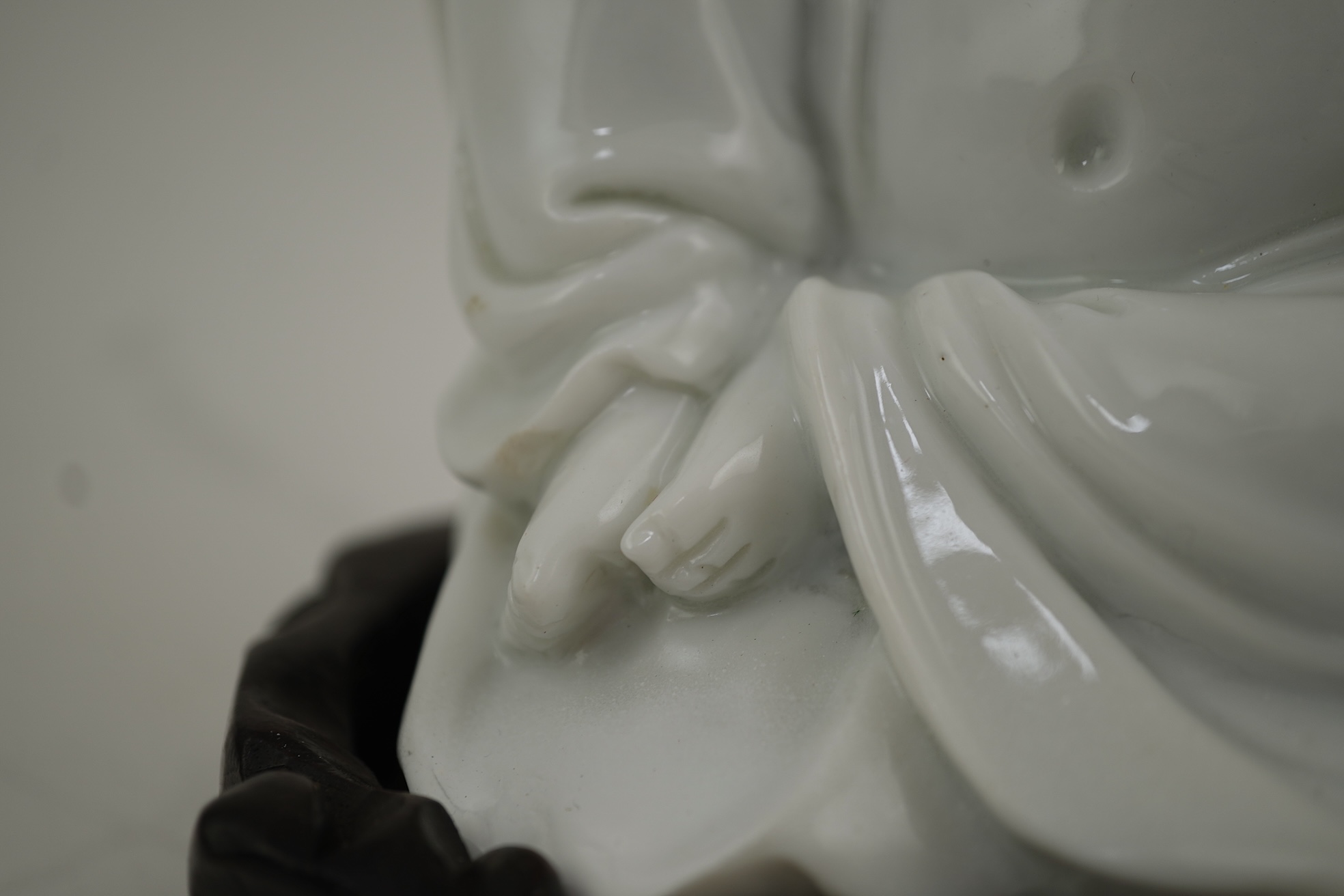 A Chinese blanc-de-chine seated figure of Budai, 18th/19th century